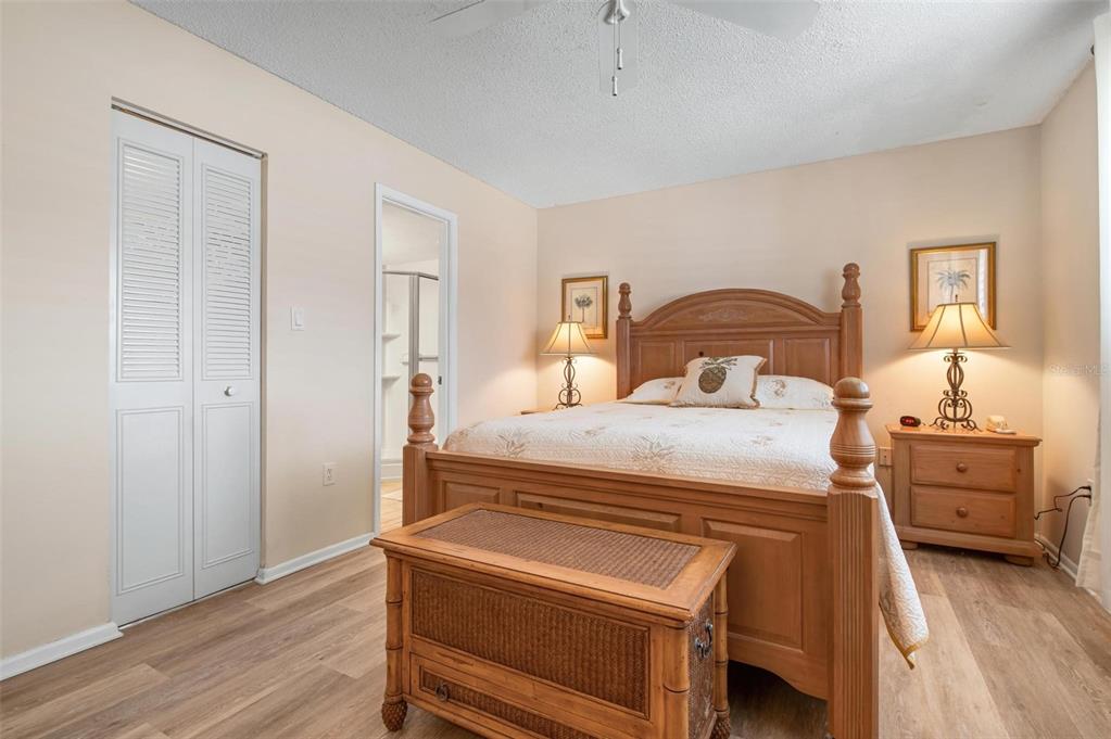 9527 Azure Cove Bradenton, FL 34210 - Photo 20 of 49 a bedroom with a bed and wooden floor