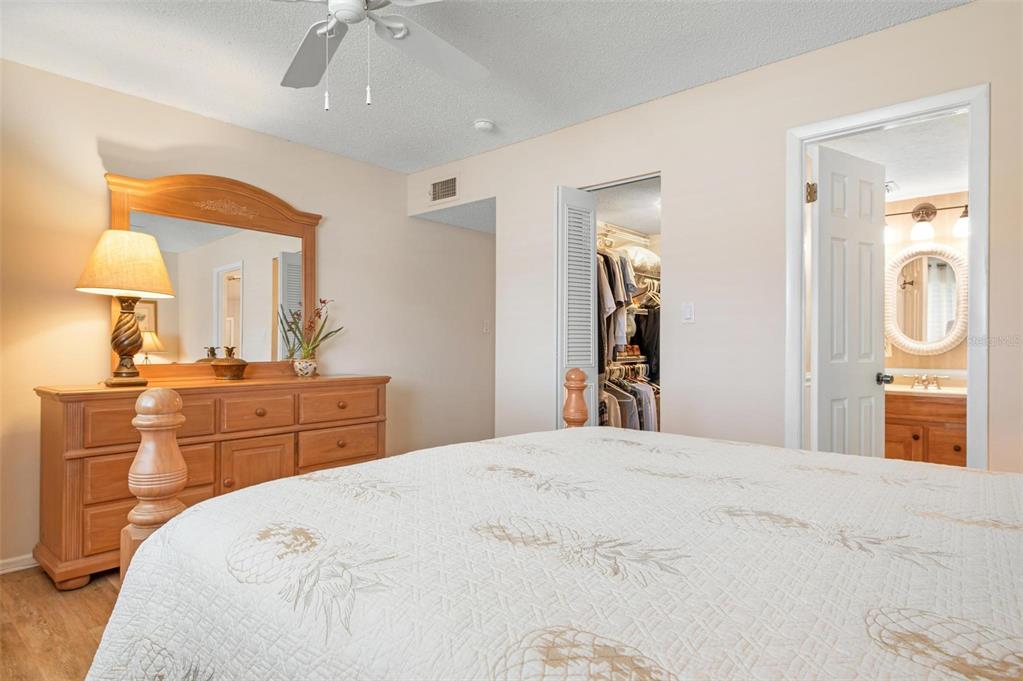 9527 Azure Cove Bradenton, FL 34210 - Photo 21 of 49 a bedroom with a bed and a mirror on dresser