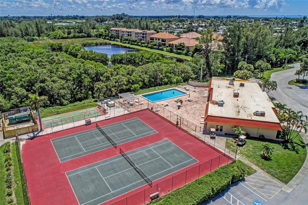 9527 Azure Cove Bradenton, FL 34210 - Photo 36 of 49 an aerial view of a tennis ground with a large trees