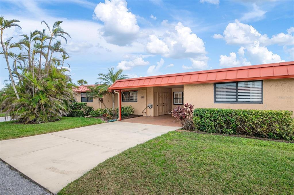 9527 Azure Cove Bradenton, FL 34210 - Photo 5 of 49 a view of a house with a yard and potted plants