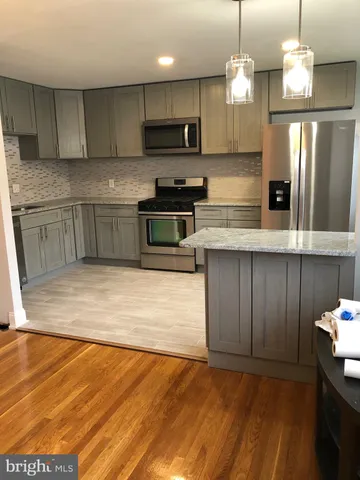 a view of room with window and wooden floor