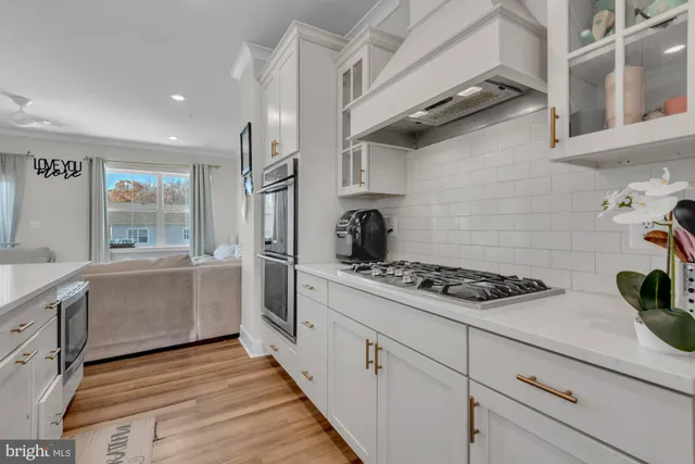 a kitchen with stainless steel appliances granite countertop a stove and a refrigerator