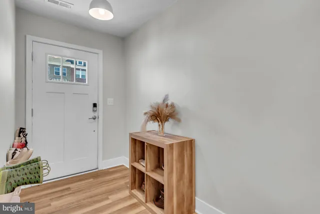 a view of entryway and hall with wooden floor