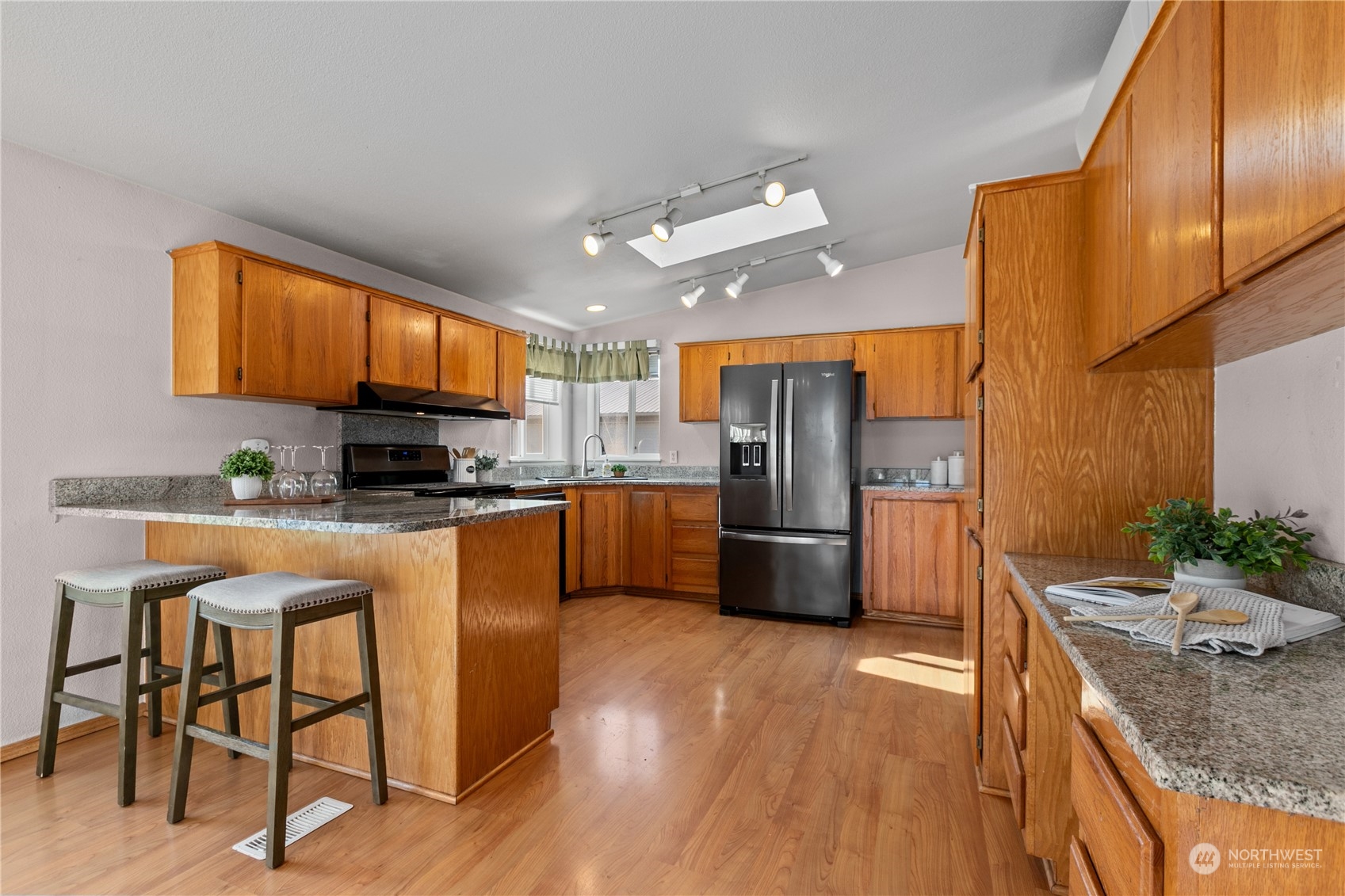 3002 Creasey Road Custer, WA 98240 - Photo 3 of 40 a kitchen with stainless steel appliances granite countertop a refrigerator a stove a sink a dining table and chairs with wooden floor