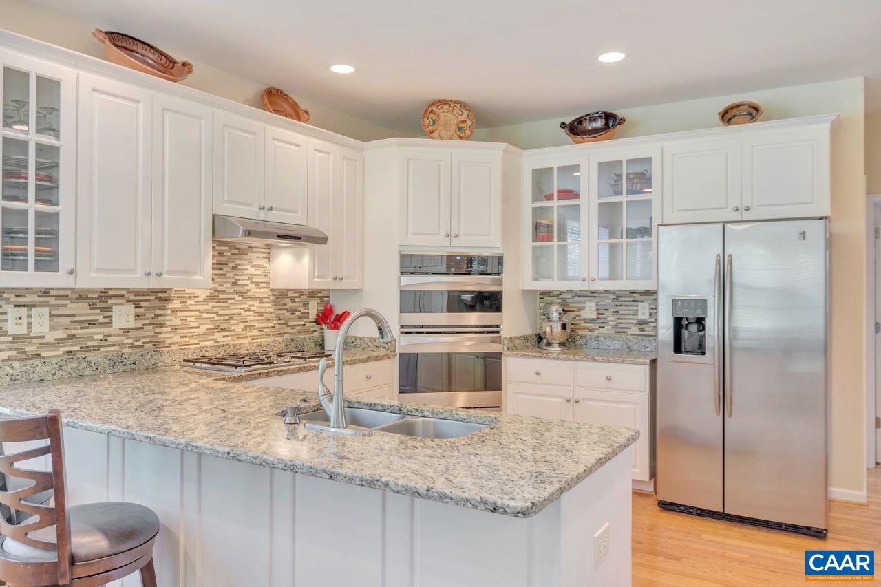 1915 Ridgetop Drive Charlottesville, VA 22903 - Photo 12 of 35 a kitchen with stainless steel appliances granite countertop a sink refrigerator and cabinets
