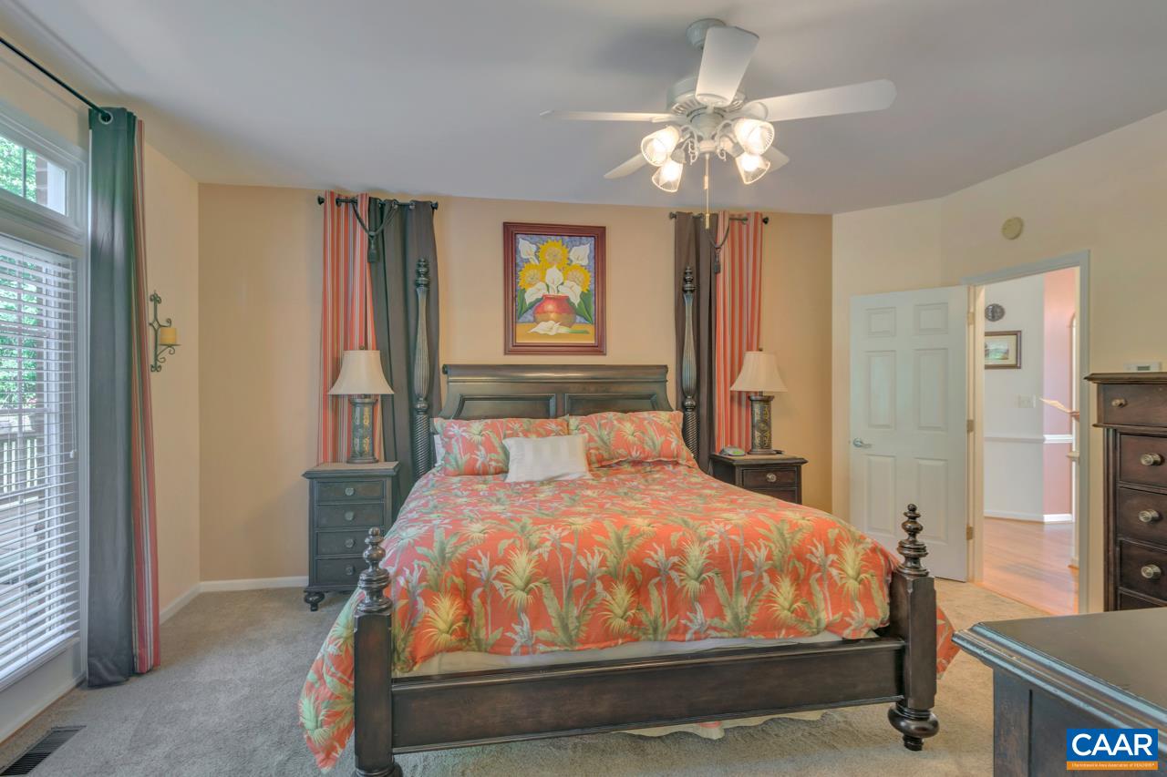 1915 Ridgetop Drive Charlottesville, VA 22903 - Photo 18 of 35 a bedroom with a bed and a chandelier