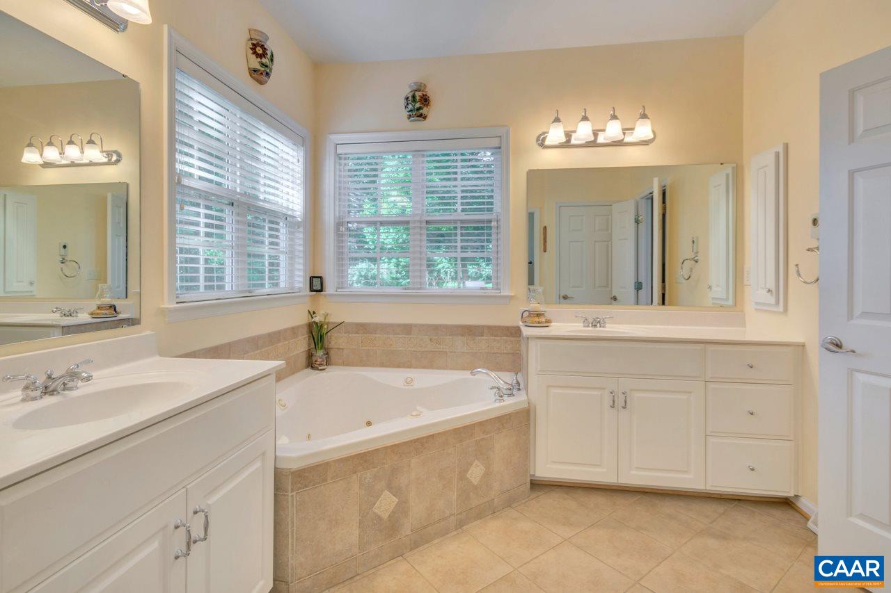 1915 Ridgetop Drive Charlottesville, VA 22903 - Photo 19 of 35 a spacious bathroom with a tub sink and mirror