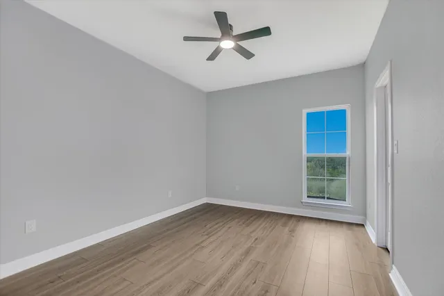 wooden floor in an empty room with a window