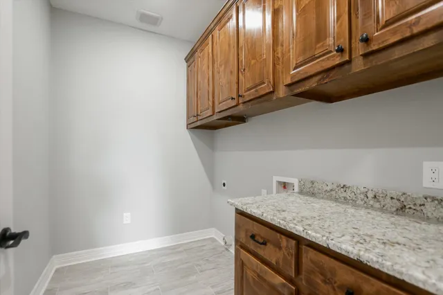 a view of kitchen with granite countertop cabinets