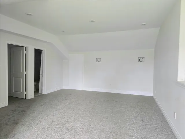 a view of a big room with window and closet area