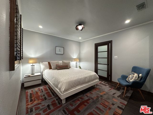 a bedroom with a bed and a lamp on table