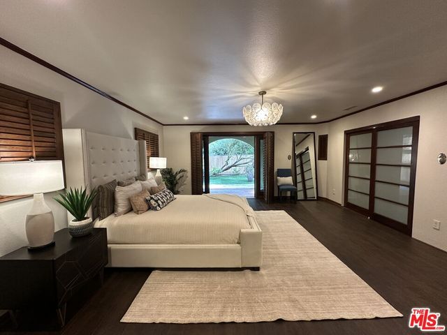 a bedroom with a large bed and a large window