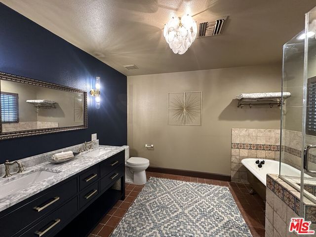 a bathroom with a sink a toilet and mirror