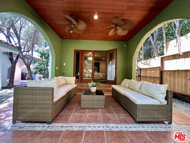 a living room with furniture a large window and a wooden floor