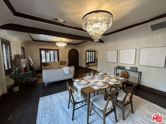 a view of a dining room with furniture and chandelier