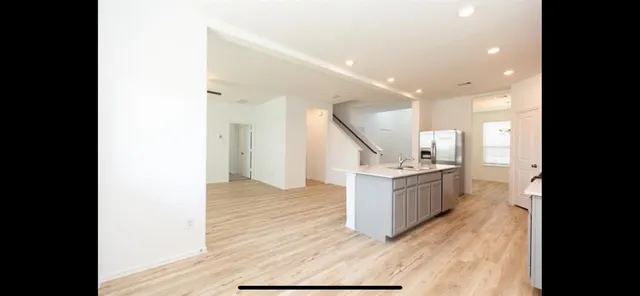 a bathroom with a glass shower door and a sink