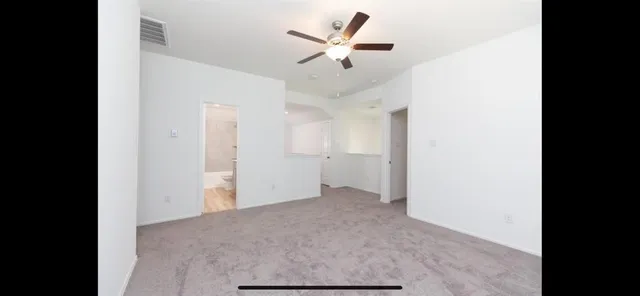 a view of a hallway with wooden floor and cabinet