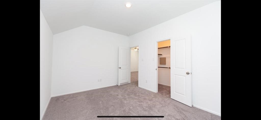 19044 Pinewood Grove Trail New Caney, TX 77357 - Photo 21 of 24 a view of a hallway with wooden floor and cabinet