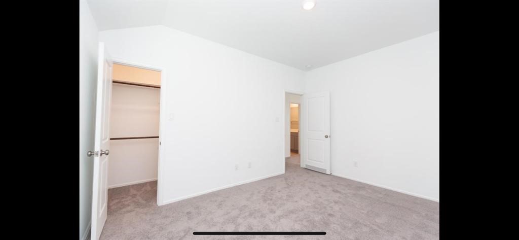 19044 Pinewood Grove Trail New Caney, TX 77357 - Photo 22 of 24 a view of a room with a hallway