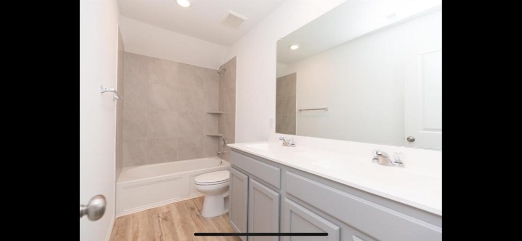 19044 Pinewood Grove Trail New Caney, TX 77357 - Photo 23 of 24 a bathroom with a sink a toilet and shower