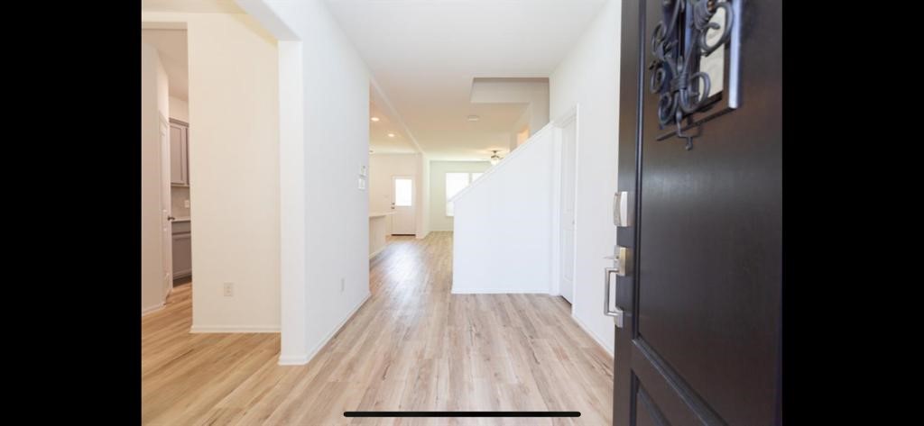 19044 Pinewood Grove Trail New Caney, TX 77357 - Photo 3 of 24 a view of a hallway with wooden floor