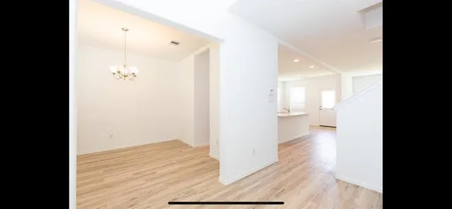 a view of a chandelier fan and wooden floor