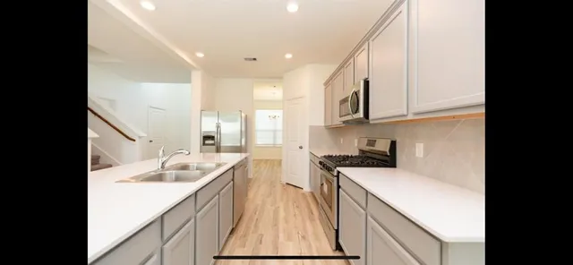 a view of a room with wooden floor and a window