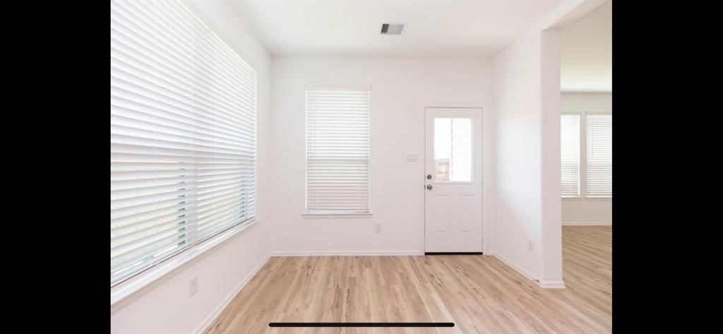 19044 Pinewood Grove Trail New Caney, TX 77357 - Photo 8 of 24 a view of a room with wooden floor and a window