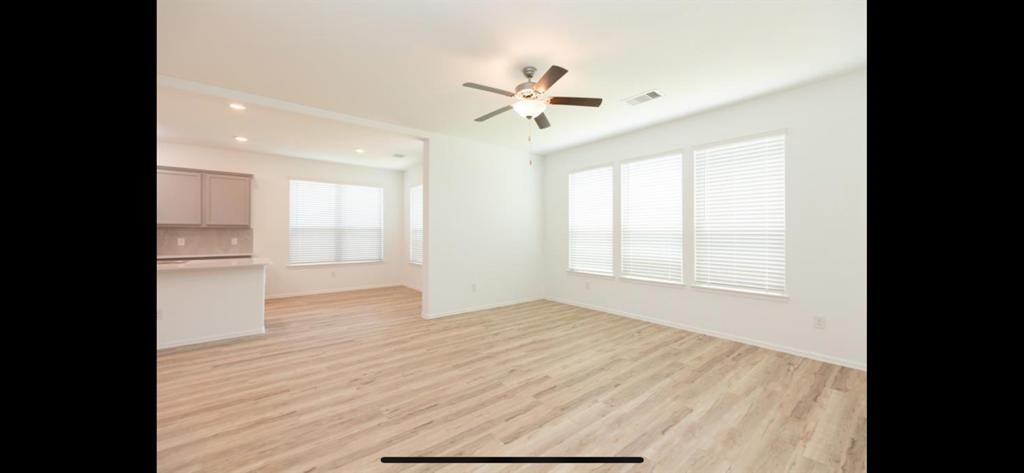 19044 Pinewood Grove Trail New Caney, TX 77357 - Photo 9 of 24 a view of empty room with wooden floor and fan
