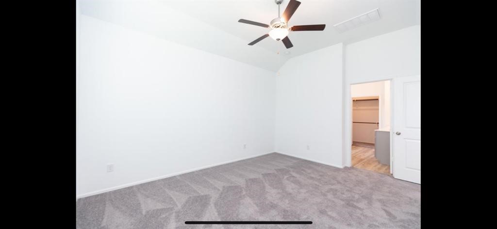 19044 Pinewood Grove Trail New Caney, TX 77357 - Photo 10 of 24 a view of empty room with a ceiling fan