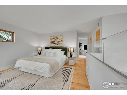 a bedroom with a bed and a painting on the wall