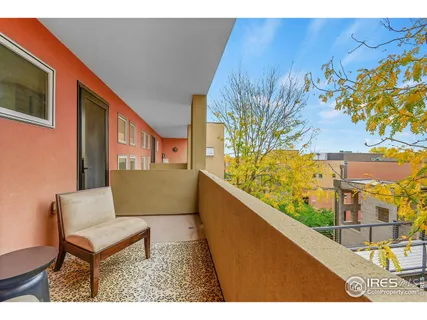 a view of a chairs and table in a balcony
