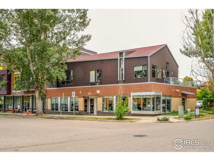 a city street lined with buildings and trees