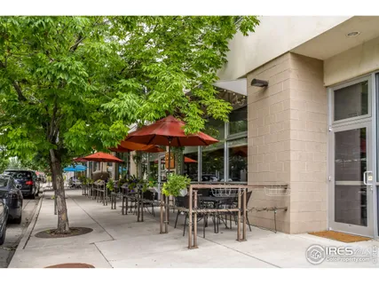 a patio with a table and chairs under an umbrella