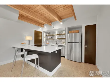 a kitchen with stainless steel appliances granite countertop a sink cabinets and refrigerator