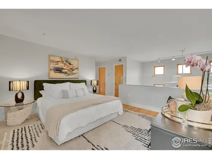 a bedroom with a bed and a potted plant