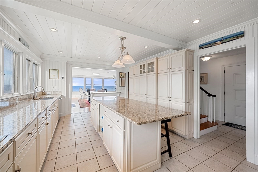 4 Priscilla Beach Road Plymouth, MA 02360 - Photo 13 of 34 a large white kitchen with a lot of counter space and glass door