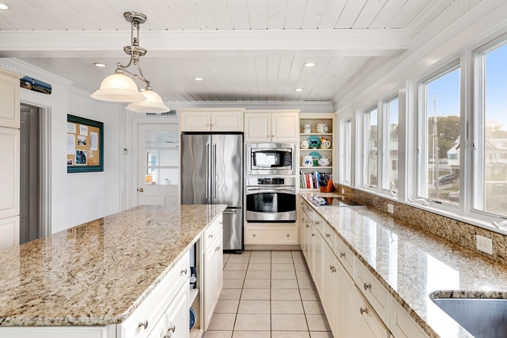 4 Priscilla Beach Road Plymouth, MA 02360 - Photo 16 of 34 a large kitchen with granite countertop a large counter top stainless steel appliances and cabinets