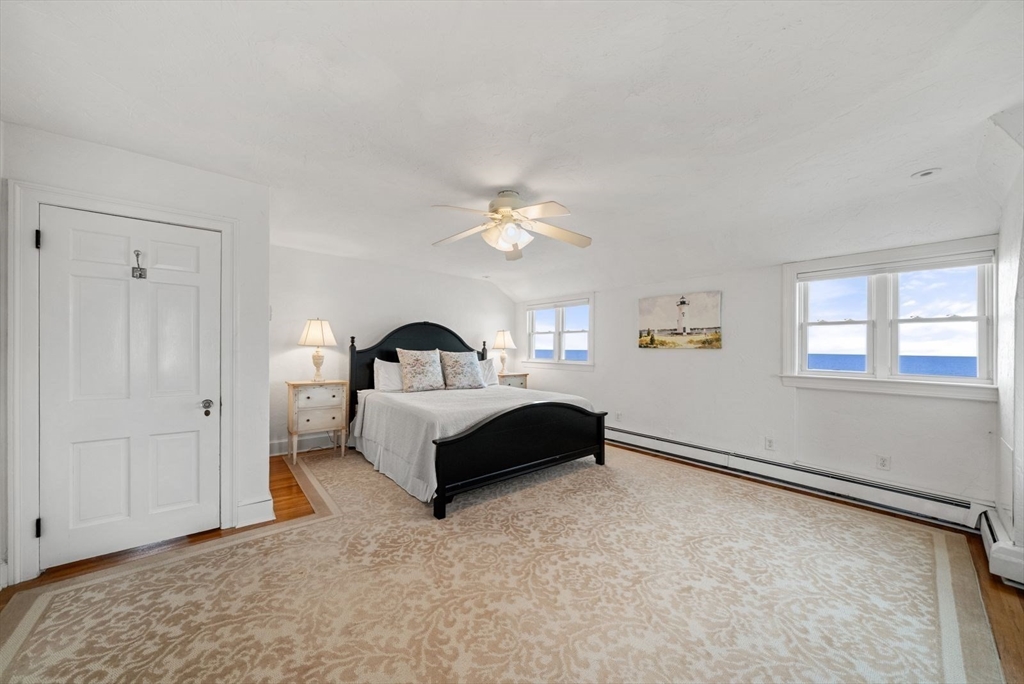 4 Priscilla Beach Road Plymouth, MA 02360 - Photo 17 of 34 a bedroom with a bed and a chandelier