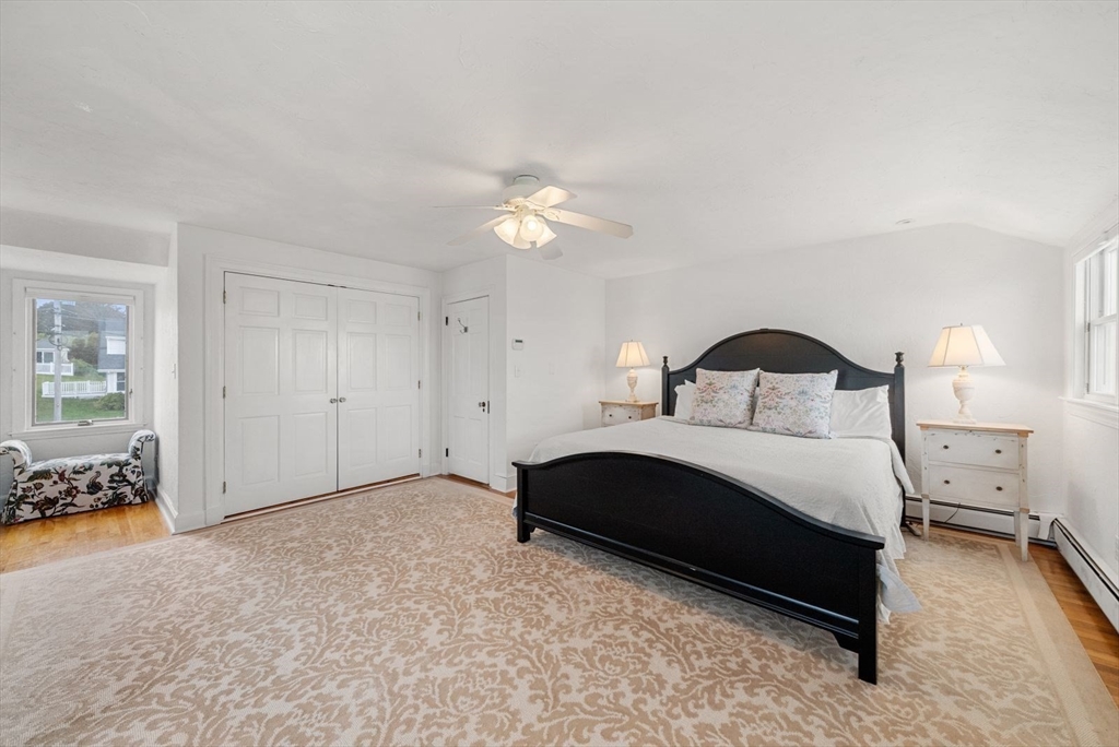 4 Priscilla Beach Road Plymouth, MA 02360 - Photo 18 of 34 a bedroom with a bed and a chandelier