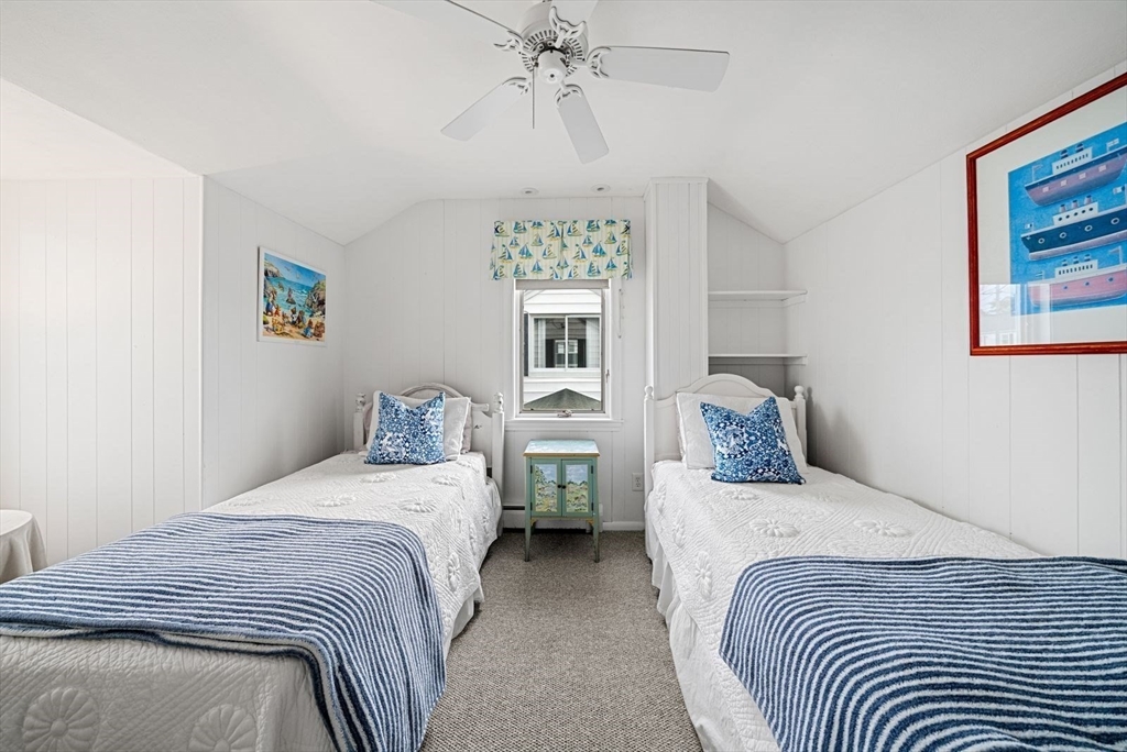 4 Priscilla Beach Road Plymouth, MA 02360 - Photo 23 of 34 a bedroom with two beds and a chandelier