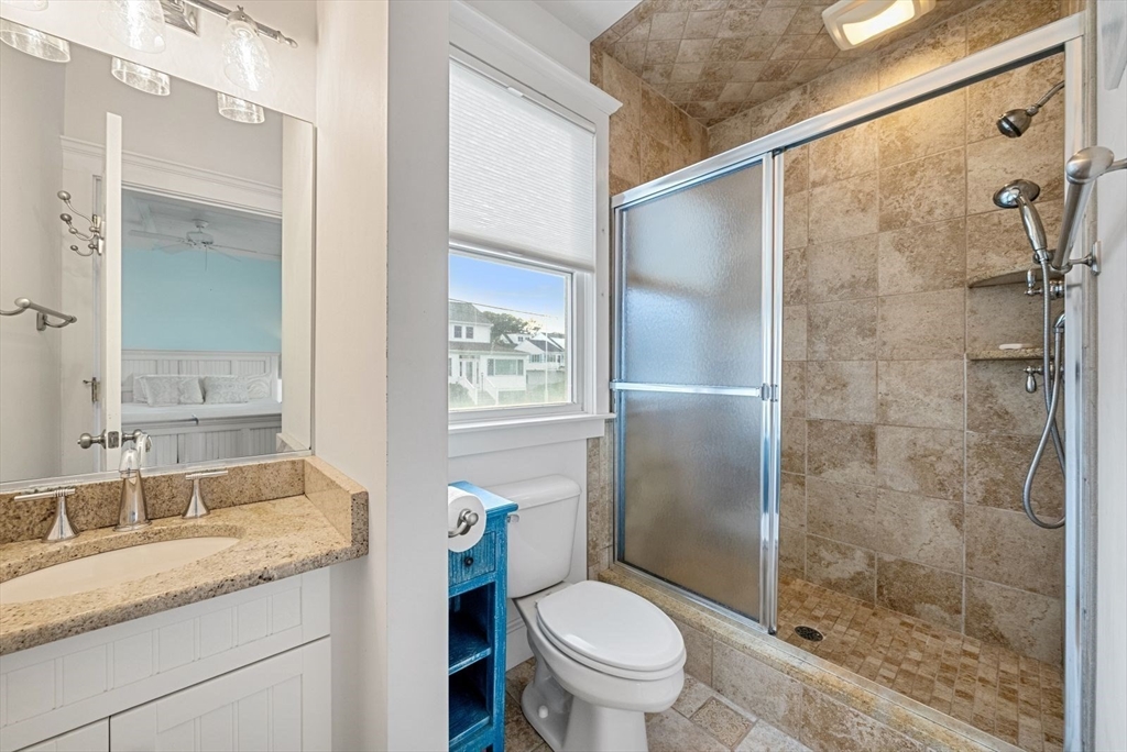 4 Priscilla Beach Road Plymouth, MA 02360 - Photo 26 of 34 a bathroom with a granite countertop shower a sink and toilet
