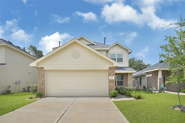 a front view of a house with a yard and garage
