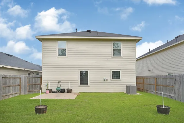 a backyard of a house with plants and pool table