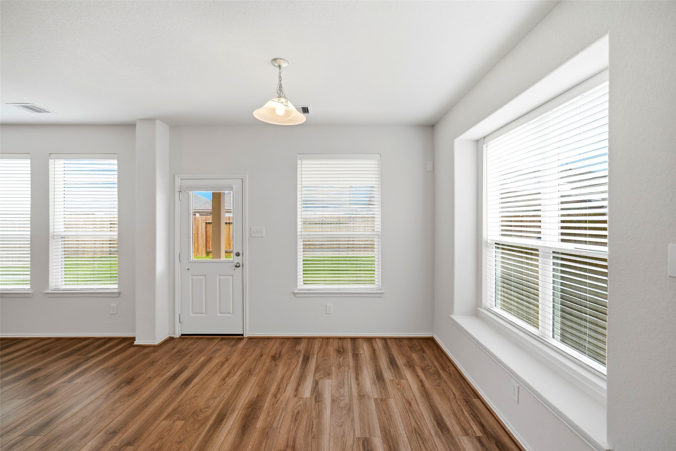 5309 Camerford Court Alvin, TX 77511 - Photo 8 of 29 a view of an empty room with wooden floor and a window
