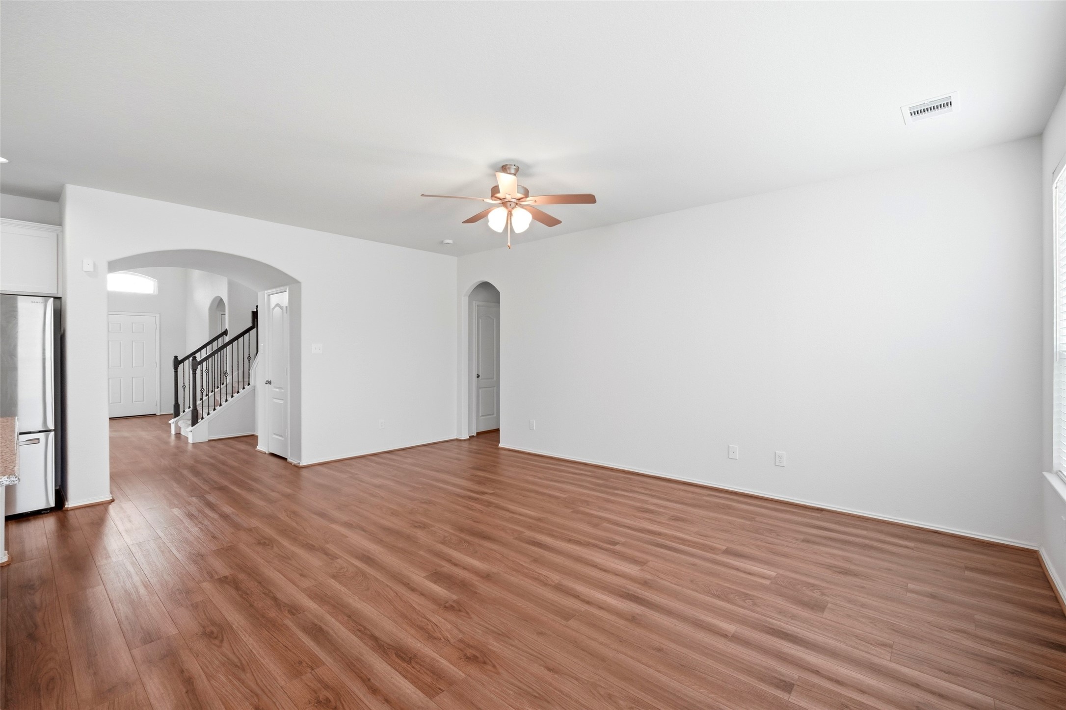 5309 Camerford Court Alvin, TX 77511 - Photo 9 of 29 a view of a room with wooden floor and a ceiling fan