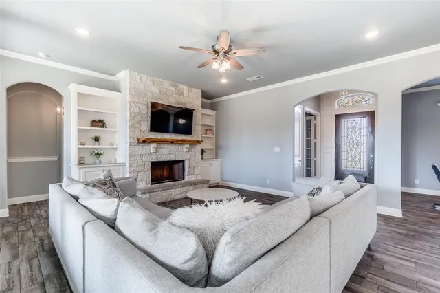 a living room with furniture a fireplace and a flat screen tv