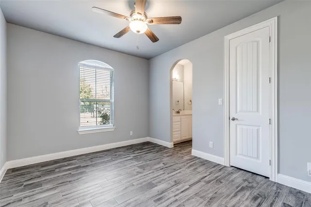 a view of a livingroom with a window and hardwood floor