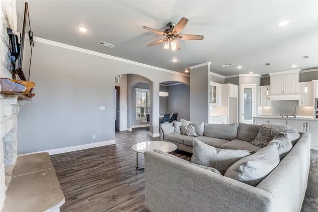 a living room with furniture and a chandelier