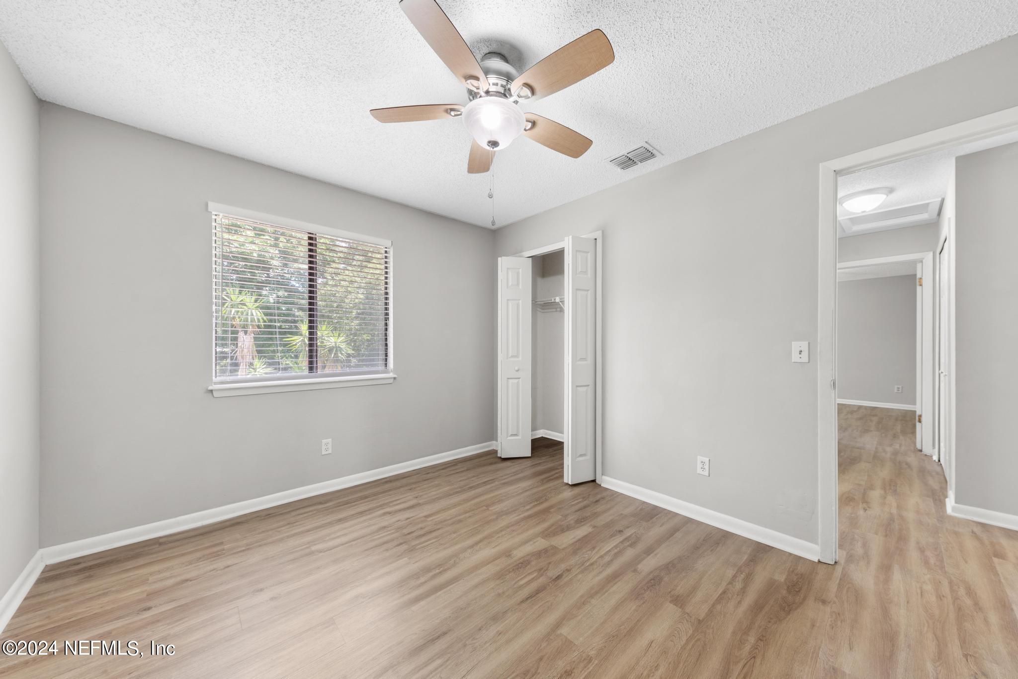 3604 Morton Street, Unit 2 Jacksonville, FL 32217 - Photo 12 of 22 an empty room with wooden floor and windows